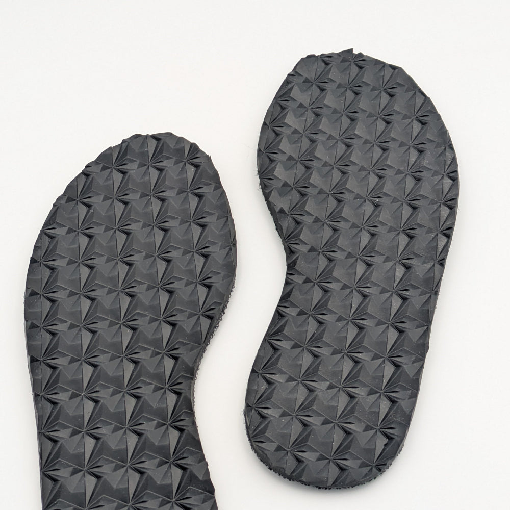 A pair of black diamond-patterned replacement soles for footwear, designed for traction on various terrains.