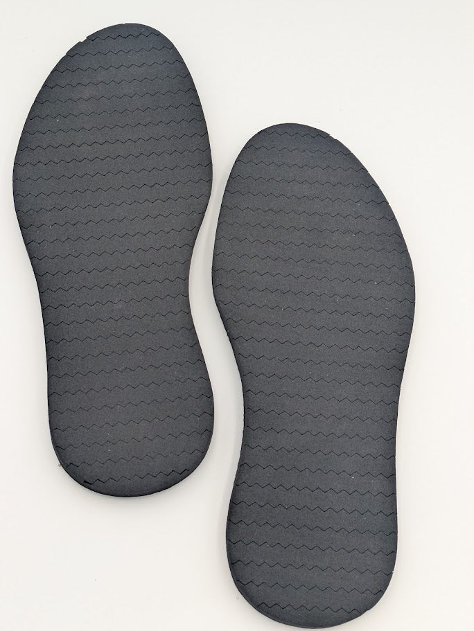 Pair of roofing shoe outsoles on a white background