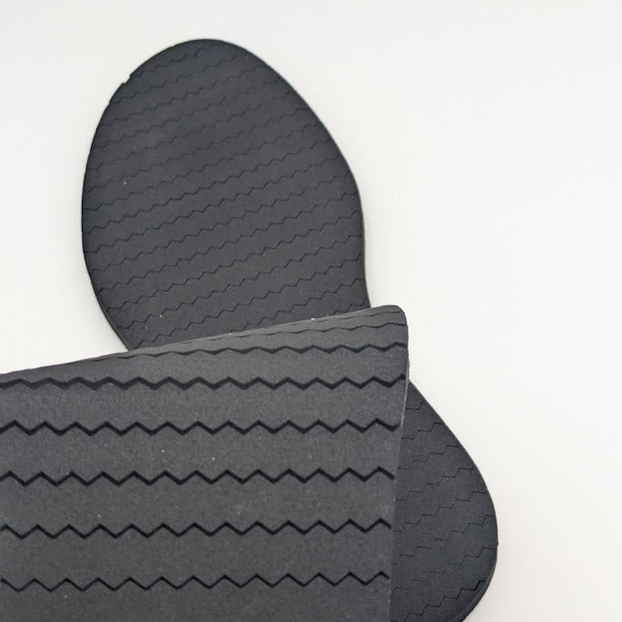 A footwear outsole pad designed for shingle roofs